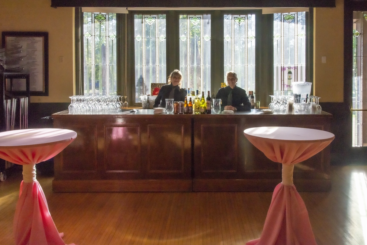 bartenders at stocked bar for private wedding